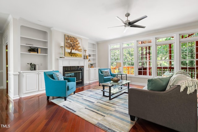 5106 Stockton Way, Durham, NC 27707 - living room featuring a fireplace, ceiling fan, wood finished floors, crown molding, and built in features