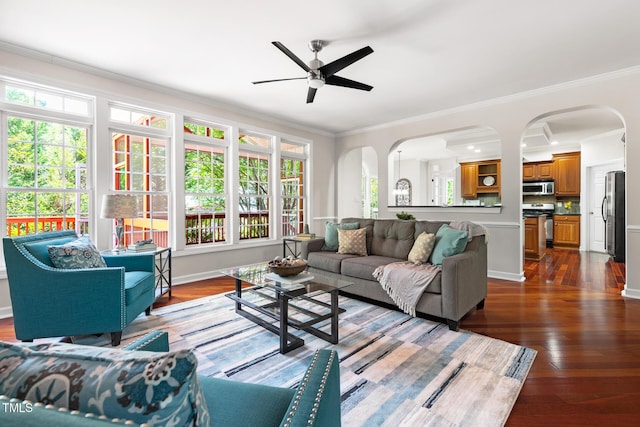 5106 Stockton Way, Durham, NC 27707 - living room featuring ceiling fan, arched walkways, dark wood-type flooring, and crown molding