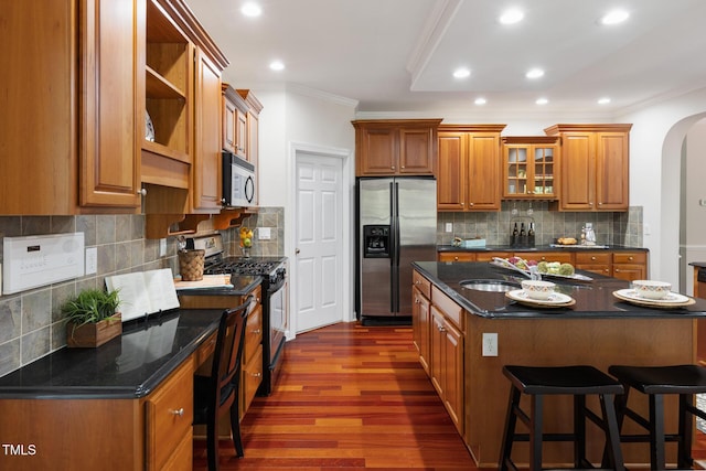5106 Stockton Way, Durham, NC 27707 - kitchen with stainless steel appliances, crown molding, arched walkways, open shelves, and dark wood-style flooring