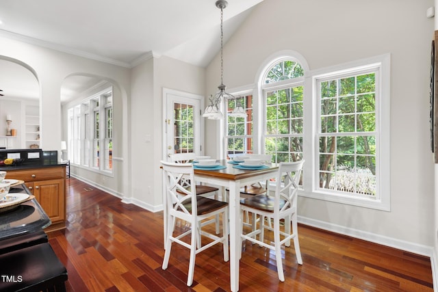5106 Stockton Way, Durham, NC 27707 - dining space featuring dark wood-style floors, arched walkways, vaulted ceiling, and ornamental molding