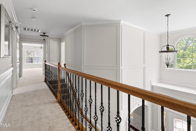 5106 Stockton Way, Durham, NC 27707 - hallway featuring a decorative wall, an upstairs landing, crown molding, and light colored carpet