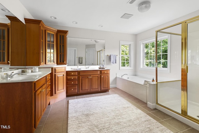 5106 Stockton Way, Durham, NC 27707 - bathroom with two vanities, a stall shower, a garden tub, and tile patterned flooring