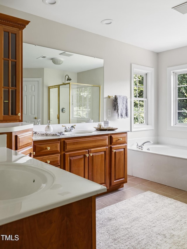 5106 Stockton Way, Durham, NC 27707 - bathroom featuring a shower stall, tile patterned flooring, vanity, and a garden tub