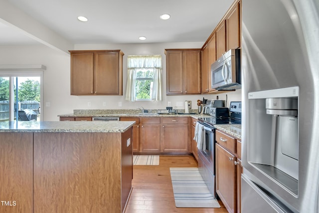 2123 Scarlet Sage Dr, Durham, NC 27704 - kitchen featuring appliances with stainless steel finishes, plenty of natural light, light wood-style flooring, recessed lighting, and light stone countertops