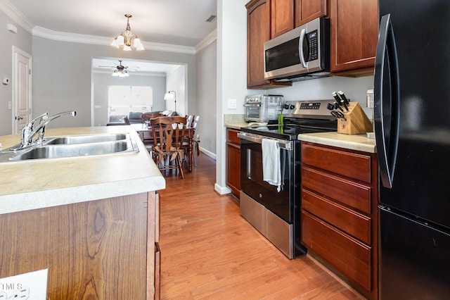 8823 Orchard Grove Way, Raleigh, NC 27612 - kitchen with stainless steel appliances, ornamental molding, light wood-type flooring, ceiling fan, and light countertops