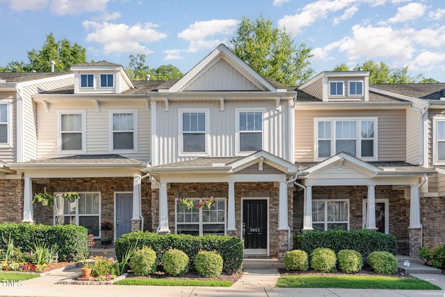 8823 Orchard Grove Way, Raleigh, NC 27612 - view of property featuring a porch, stone siding, and roof with shingles
