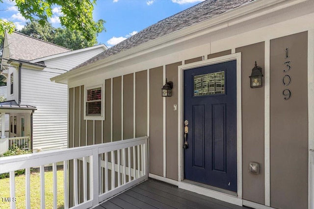 1309 Hill St, Durham, NC 27707 - property entrance featuring a shingled roof, covered porch, and board and batten siding