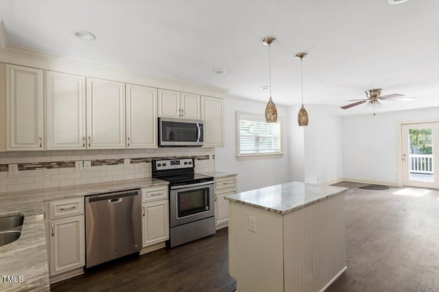 1309 Hill St, Durham, NC 27707 - kitchen with appliances with stainless steel finishes, decorative backsplash, dark wood finished floors, a ceiling fan, and recessed lighting