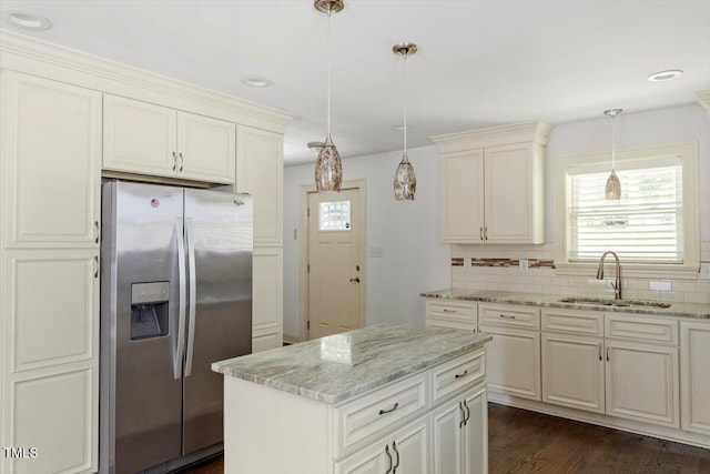 1309 Hill St, Durham, NC 27707 - kitchen featuring stainless steel fridge with ice dispenser, decorative backsplash, plenty of natural light, and light stone countertops