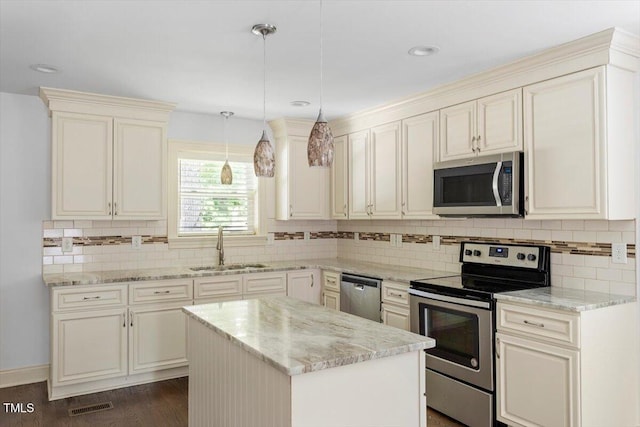 1309 Hill St, Durham, NC 27707 - kitchen with stainless steel appliances, tasteful backsplash, light stone countertops, dark wood-style floors, and recessed lighting
