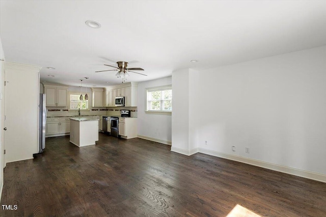 1309 Hill St, Durham, NC 27707 - unfurnished living room with a ceiling fan, dark wood-style flooring, and recessed lighting