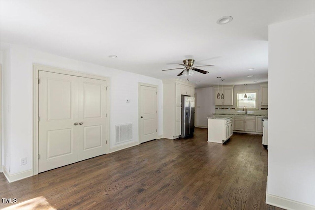 1309 Hill St, Durham, NC 27707 - unfurnished living room featuring a ceiling fan, dark wood-style flooring, and recessed lighting