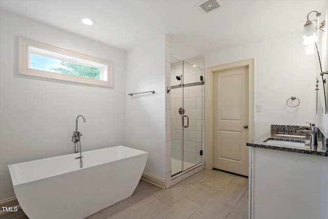 1309 Hill St, Durham, NC 27707 - full bathroom featuring a freestanding bath, a shower stall, and double vanity