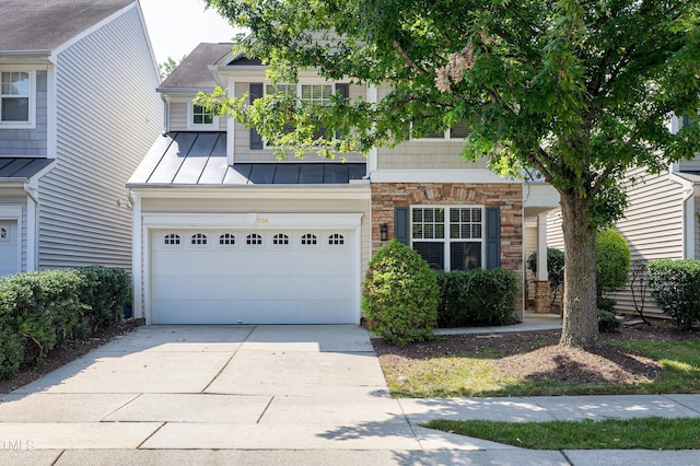 238 Royal Tower Way, Cary, NC 27513 - view of front facade with a standing seam roof, driveway, an attached garage, a metal roof, and stone siding