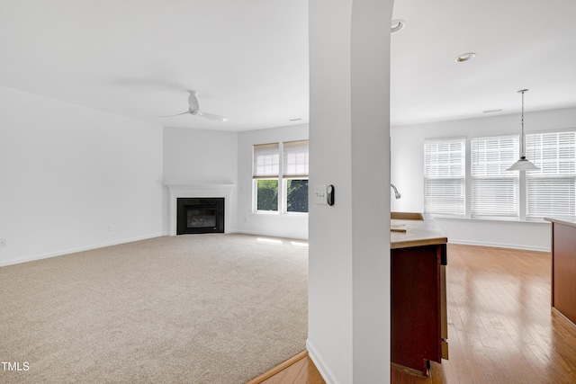 238 Royal Tower Way, Cary, NC 27513 - unfurnished living room with a ceiling fan, a glass covered fireplace, and recessed lighting