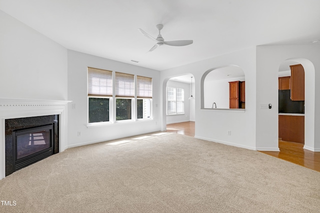 238 Royal Tower Way, Cary, NC 27513 - unfurnished living room featuring carpet, ceiling fan, and a glass covered fireplace