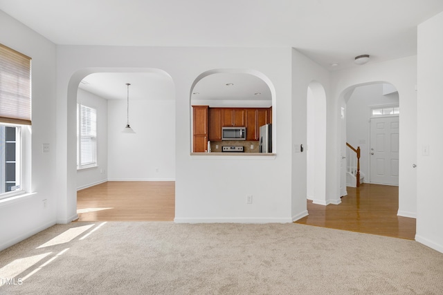 238 Royal Tower Way, Cary, NC 27513 - unfurnished living room with carpet floors and arched walkways