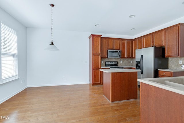 238 Royal Tower Way, Cary, NC 27513 - kitchen featuring appliances with stainless steel finishes, tasteful backsplash, plenty of natural light, brown cabinetry, and recessed lighting