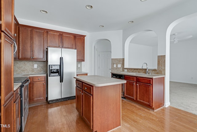 238 Royal Tower Way, Cary, NC 27513 - kitchen featuring appliances with stainless steel finishes, a kitchen island, light wood finished floors, light countertops, and recessed lighting
