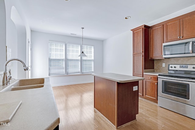 238 Royal Tower Way, Cary, NC 27513 - kitchen with appliances with stainless steel finishes, a center island, decorative backsplash, light wood-style floors, and recessed lighting