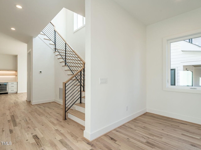 1009 Parker St, Raleigh, NC 27607 - stairs featuring wood finished floors, beverage cooler, and recessed lighting