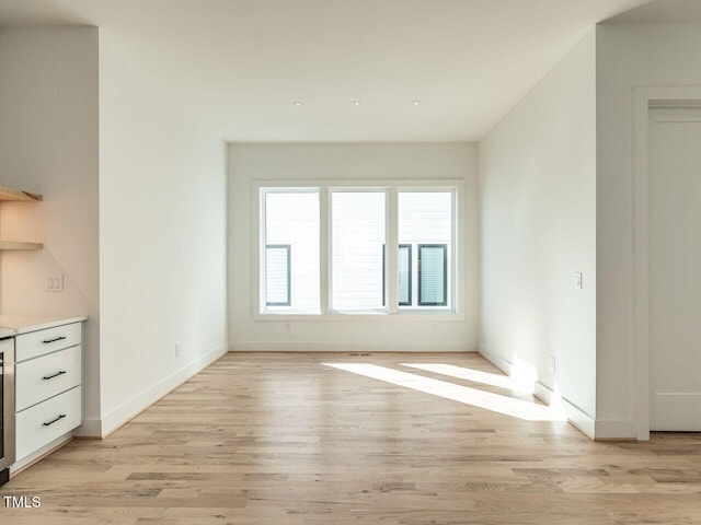 1009 Parker St, Raleigh, NC 27607 - unfurnished living room with light wood-style floors and wine cooler