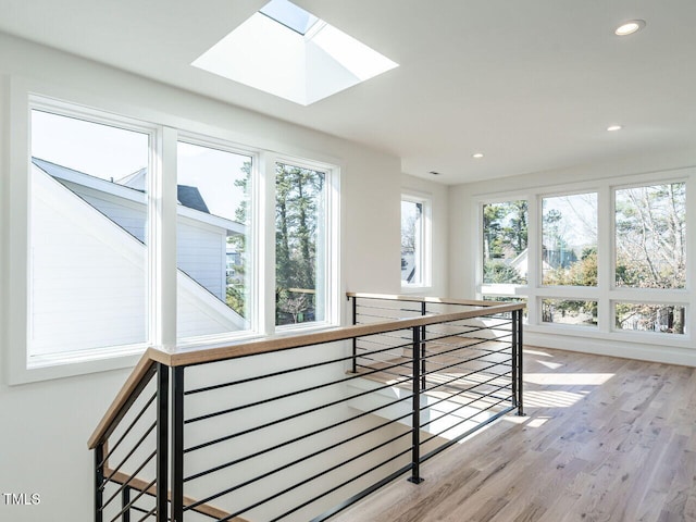 1009 Parker St, Raleigh, NC 27607 - hallway with an upstairs landing, wood finished floors, recessed lighting, and a skylight