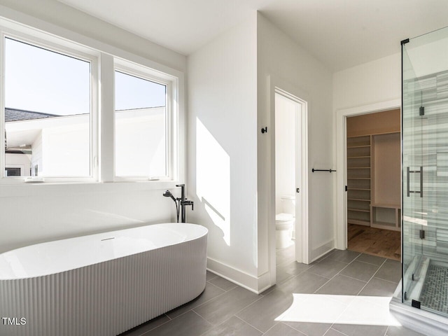 1009 Parker St, Raleigh, NC 27607 - bathroom featuring a shower stall, a soaking tub, and tile patterned flooring