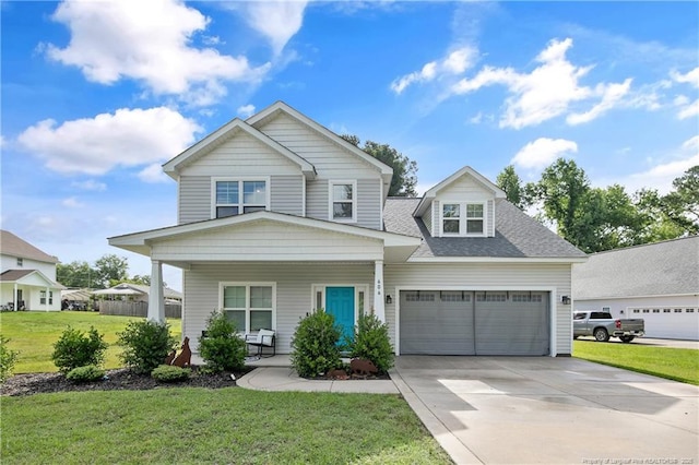 606 N Dickson St, Raeford, NC 28376 - view of front of property featuring a porch, driveway, a front yard, an attached garage, and roof with shingles