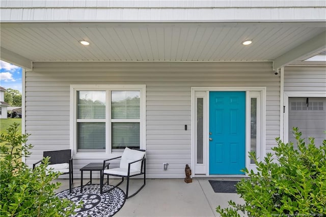 606 N Dickson St, Raeford, NC 28376 - view of exterior entry featuring covered porch and a security system