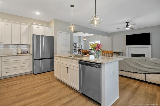 606 N Dickson St, Raeford, NC 28376 - kitchen featuring stainless steel appliances, white cabinets, tasteful backsplash, ceiling fan, and open floor plan