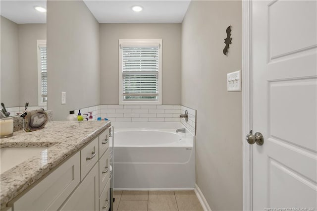 606 N Dickson St, Raeford, NC 28376 - bathroom with vanity, a garden tub, and tile patterned flooring