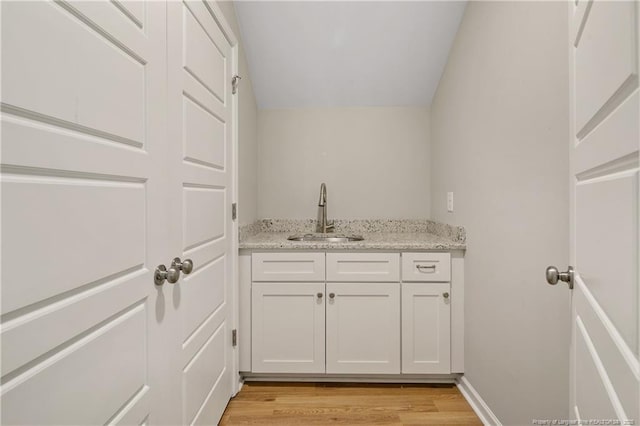 606 N Dickson St, Raeford, NC 28376 - indoor wet bar featuring light wood-style floors