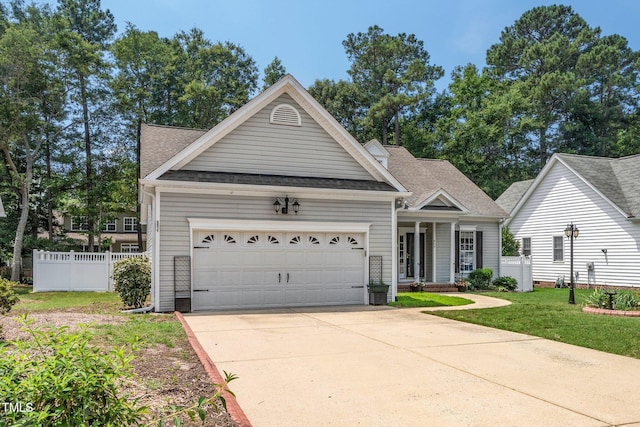 904 E Ivy Valley Dr, Fuquay Varina, NC 27526 - view of front of house with a garage, driveway, a shingled roof, and a porch