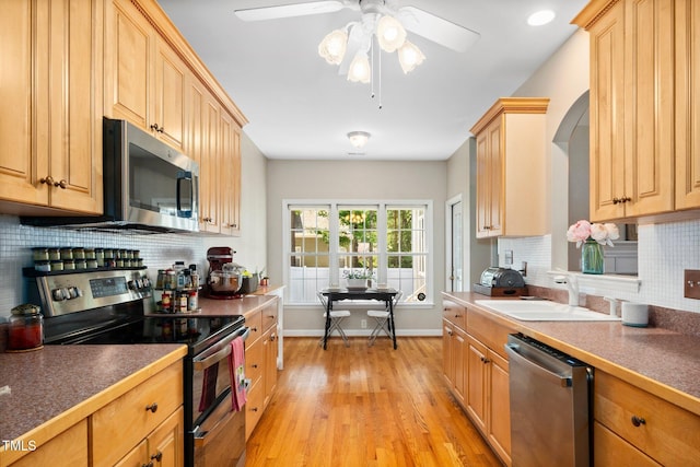 904 E Ivy Valley Dr, Fuquay Varina, NC 27526 - kitchen featuring stainless steel appliances, light wood-style flooring, decorative backsplash, ceiling fan, and light brown cabinets