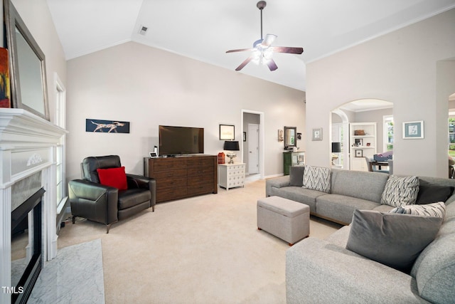 904 E Ivy Valley Dr, Fuquay Varina, NC 27526 - living room with ceiling fan, a high end fireplace, arched walkways, light carpet, and crown molding