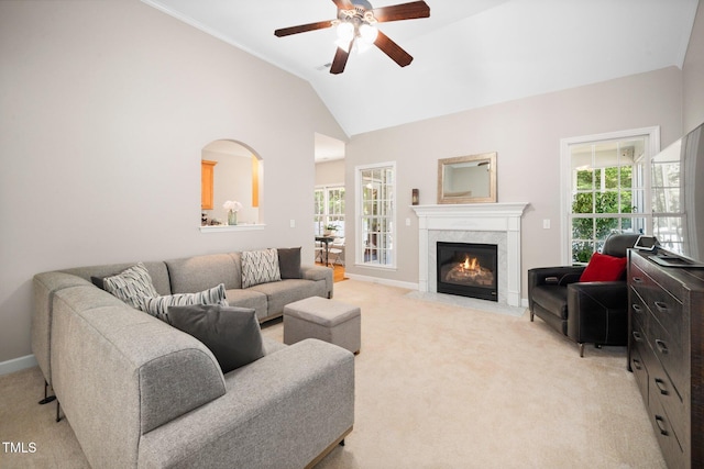 904 E Ivy Valley Dr, Fuquay Varina, NC 27526 - living area with light colored carpet, healthy amount of natural light, a ceiling fan, vaulted ceiling, and a fireplace