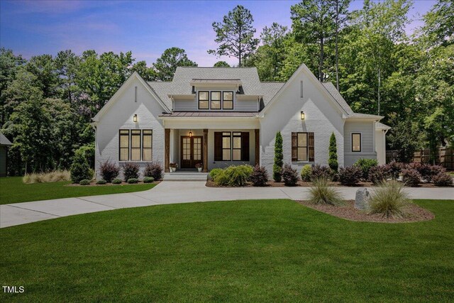 8420 Bells Lake Rd, Apex, NC 27539 - modern farmhouse with a front yard, a standing seam roof, french doors, and a metal roof