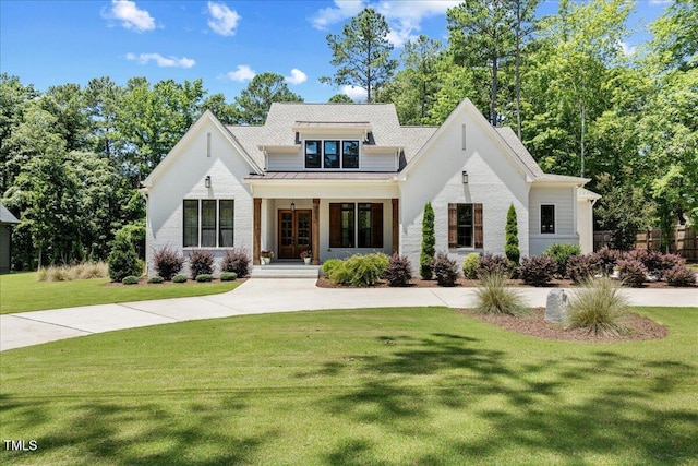 8420 Bells Lake Rd, Apex, NC 27539 - modern farmhouse style home featuring a front yard, a standing seam roof, covered porch, and a metal roof