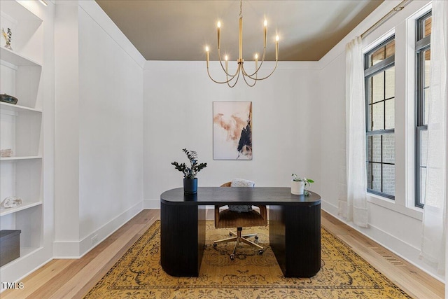 8420 Bells Lake Rd, Apex, NC 27539 - home office featuring wood finished floors, a chandelier, and built in shelves