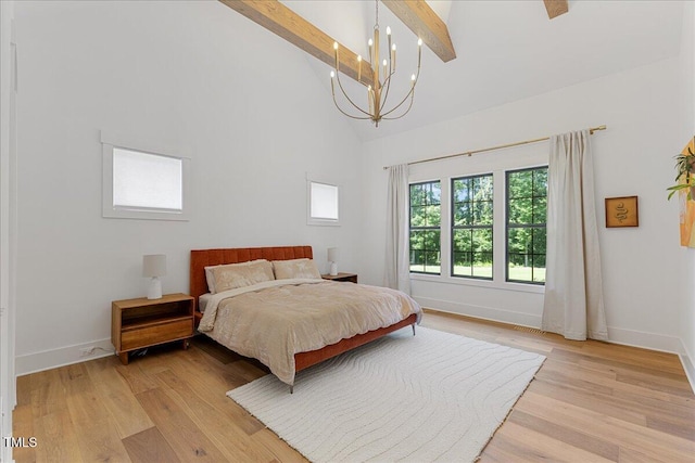 8420 Bells Lake Rd, Apex, NC 27539 - bedroom with a chandelier, high vaulted ceiling, light wood-style flooring, and beamed ceiling