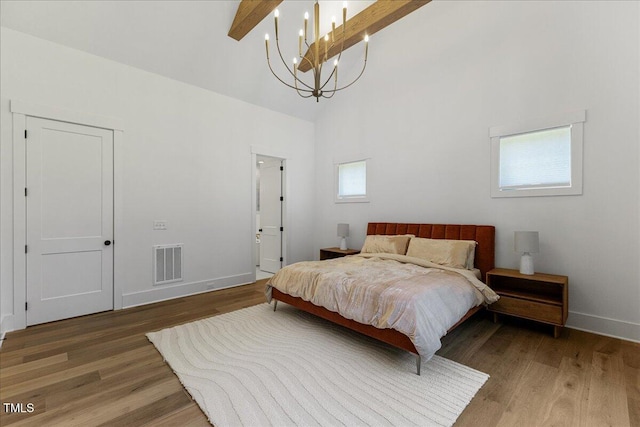8420 Bells Lake Rd, Apex, NC 27539 - bedroom with wood finished floors, high vaulted ceiling, and beam ceiling