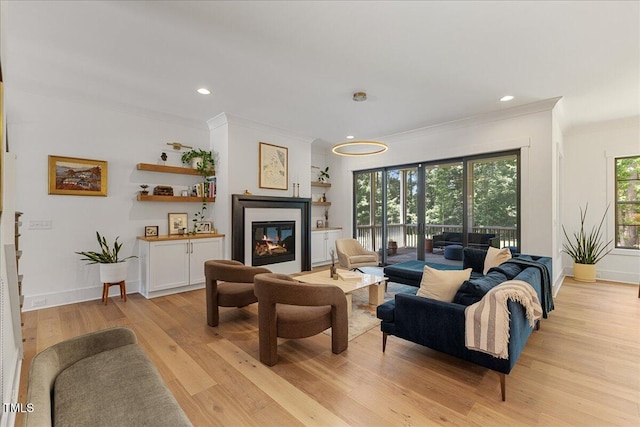 8420 Bells Lake Rd, Apex, NC 27539 - living room featuring ornamental molding, light wood-style floors, a glass covered fireplace, and recessed lighting