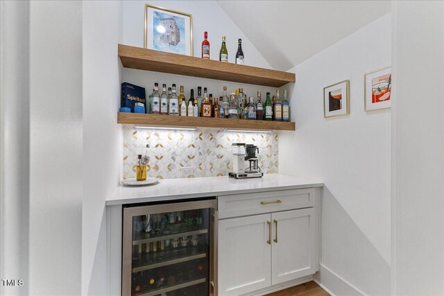 8420 Bells Lake Rd, Apex, NC 27539 - indoor dry bar featuring wine cooler, backsplash, and vaulted ceiling