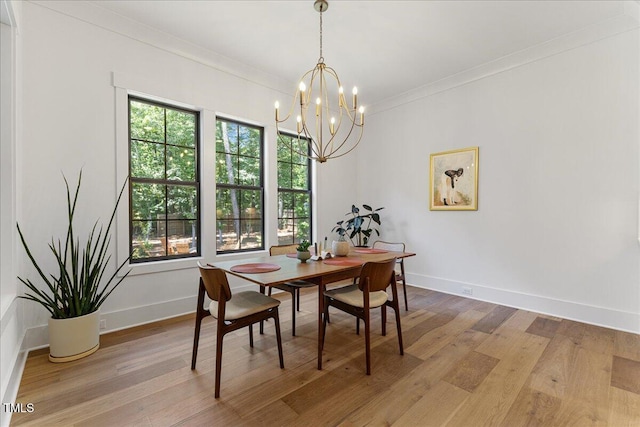 8420 Bells Lake Rd, Apex, NC 27539 - dining space featuring a chandelier, light wood-type flooring, and crown molding