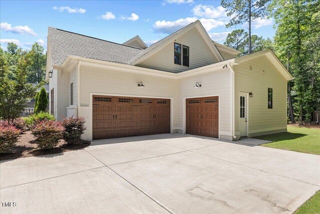 8420 Bells Lake Rd, Apex, NC 27539 - view of side of property with driveway, an attached garage, and roof with shingles