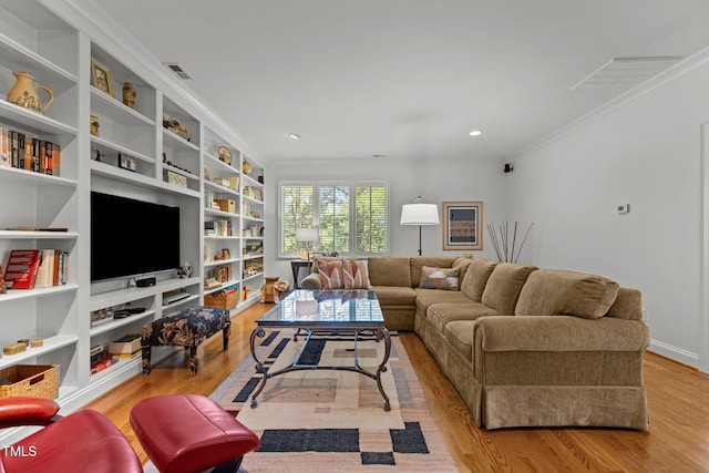 145 Cofield Cir, Durham, NC 27707 - living room featuring wood finished floors, ornamental molding, built in shelves, and recessed lighting