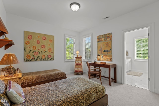 145 Cofield Cir, Durham, NC 27707 - carpeted bedroom with multiple windows and ensuite bathroom