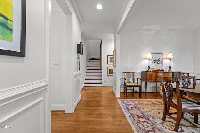 145 Cofield Cir, Durham, NC 27707 - hallway featuring crown molding, stairway, light wood-style floors, wainscoting, and recessed lighting