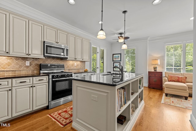 145 Cofield Cir, Durham, NC 27707 - kitchen featuring appliances with stainless steel finishes, ornamental molding, light wood-type flooring, cream cabinets, and recessed lighting
